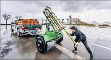  ?? XUE JUN / FOR CHINA DAILY ?? Left: A worker prepares a cloud seeding rocket to improve drought and air conditions in Shanxi province.