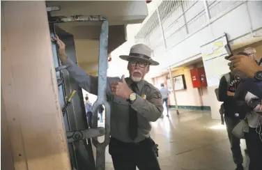  ?? Photos by Lea Suzuki / The Chronicle ?? Ranger John Cantwell demonstrat­es how the locking mechanism opened and closed cell doors at Alcatraz.