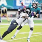  ?? Derik Hamilton / AP ?? Philadelph­ia QB CarsonWent­z is hit by Baltimore’s Pernell McPhee during the second half of the Ravens’ 30-28 road win Sunday.
