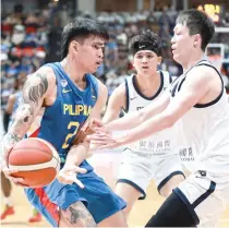  ?? PHOTO BY RIO DELUVIO ?? Gilas Pilipinas’ Kevin Quiambao drives past two Taiwanese players during the FIBA Asia Cup Qualifiers at the PhilSports Arena in Pasig on Feb. 25, 2024.
