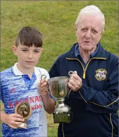  ??  ?? Michael Carthy presenting the Wally Doyle Memorial Cup to Des O’Connor, the Bunclody captain.