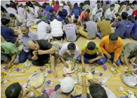  ?? Photo by Ryan Lim ?? People end their fast with Iftar meals provided at the Emirates Red Crescent Ramadan tent in Abu Dhabi. —