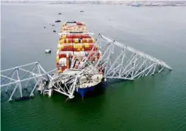  ?? MARYLAND NATIONAL GUARD VIA ASSOCIATED PRESS ?? The cargo ship Dali was stuck under part of the Francis Scott Key Bridge after the ship hit the bridge March 26