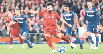 ?? — Reuters photo ?? Liverpool’s Mohamed Salah scores their third goal from a penalty during the UEFA Champions League group C match against Red Star Belgrade at Anfield in Liverpool, north west England.