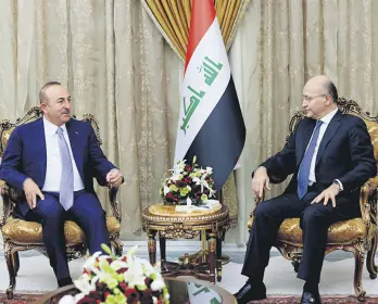  ??  ?? Turkish Foreign Minister Mevlüt Çavuşoğlu (L) meets with Iraqi President Barham Salih in Baghdad, yesterday.