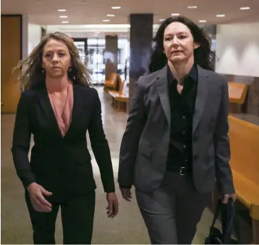  ?? Ryan Michalesko/The Dallas Morning News via AP, File ?? ■ Former Dallas police officer Amber Guyger, left, walks the hallway June 6 at the Frank Crowley Courts Building in Dallas. Prosecutor­s have objected to Guyger’s request that her murder trial for fatally shooting a neighbor in his own apartment be relocated.