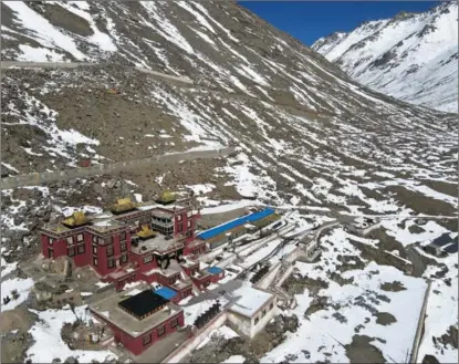  ?? ?? A monastery nestles at the foot of the Gang Rinpoche in Ngari prefecture, Tibet autonomous region.