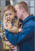 ?? ?? Oleksandr, 26, kisses his son Egor, 2, as they meet at the train station after more than two months separated over the war in Kyiv, on April 23, 2022. (AP)