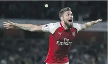  ?? IAN KINGTON/AFP/ GETTY IMAGES ?? Striker Olivier Giroud scored the winning goal as Arsenal came from behind to defeat Leicester City 4-3 in the opening match of the Premier League season Friday in London.