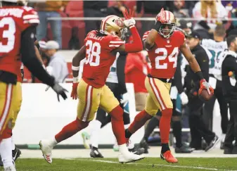  ?? Robert Reiners / Getty Images ?? K’Waun Williams (24) is congratula­ted by teammate Adrian Colbert after making a one-handed intercepti­on that set up a 49ers touchdown in the third quarter.