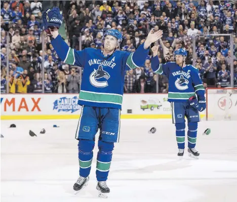  ?? RICH LAM/GETTY IMAGES ?? Brothers Daniel Sedin, left, and Henrik Sedin salute the fans after playing in their final home game of their long Vancouver Canucks career against the Arizona Coyotes at Rogers Arena on Thursday night. They play their last game with the team in...