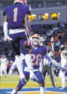  ??  ?? Bishop Gorman wide receiver Zachariah Branch (1) celebrates a first-quarter touchdown catch with teammate Jeremiah Hughes. Branch had six catches for 117 yards and three TDS.