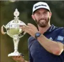  ?? NATHAN DENETTE — THE CANADIAN PRESS VIA AP ?? Dustin Johnson hoists the Canadian Open championsh­ip trophy at the Glen Abbey Golf Club in Oakville, Ontario on Sunday. Top-ranked Johnson shot a 6-under 66 for a three-stroke victory, his third win of the season and 19th on the PGA Tour.