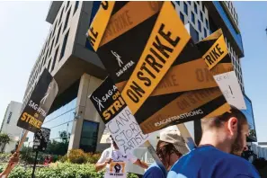  ?? (AP Photo/Damian Dovarganes) ?? SAG-AFTRA actors walk on a picket line outside Netflix studios on Tuesday, Sep. 26, 2023, in Los Angeles.