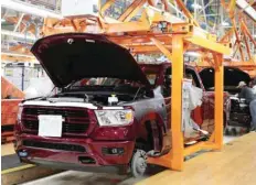  ??  ?? Workers build 2019 Ram pick-up trucks on ‘Verticle Adjusting Carriers’ at the FCA Sterling Heights Assembly Plant in Sterling Heights, Michigan. — Reuters