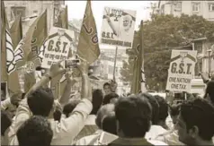  ?? AFP ?? BJP workers at a rally to support the GST regime in Mumbai. The informal sector is almost 40% of the Indian economy and employs nearly 75% of the labour force.