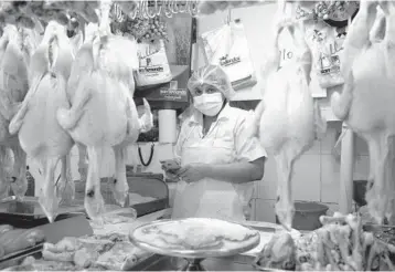  ?? ?? for customers in her stall Saturday at a central market in Lima, Peru. Inflation will continue to be a regional headache coupled with a lack of investment, according to a recent forecast offered by the Economic Commission for Latin America and the Caribbean.