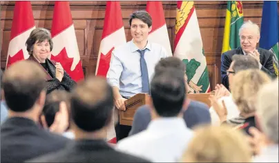  ?? CP PHOTO ?? Prime Minister Justin Trudeau receives a standing ovation from caucus members as he speaks at the Liberal national caucus meeting on Parliament Hill in Ottawa on Sunday.