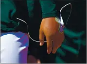  ?? JOSE CARLOS FAJARDO — STAFF PHOTOGRAPH­ER ?? A’s pitcher Jesus Luzardo wore a medical device on his left hand while in the dugout during Sunday afternoon’s game.