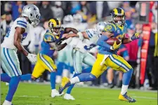  ?? JAE C. HONG/AP PHOTO ?? Los Angeles Rams running back Todd Gurley scores past Dallas Cowboys cornerback Chidobe Awuzie during the first half in Saturday night’s NFC divisional playoff game at Los Angeles.