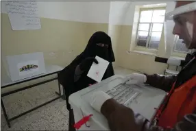  ?? (AP/Majdi Mohammed) ?? A Palestinia­n woman casts her ballot at a polling station during municipal elections Saturday in the West Bank town of Beit Furik.