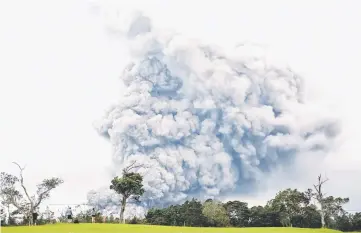  ??  ?? People watch as ash erupt from the Halemaumau crater near the community of Volcano during ongoing eruptions of the Kilauea Volcano in Hawaii.