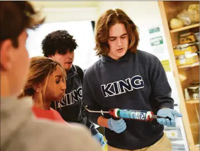  ?? Tyler Sizemore / Hearst Connecticu­t Media ?? King School Frog Conservati­on Project President Duncan Baird shows his classmates how to build environmen­ts for the frog vivarium at King School in Stamford on Nov. 17.