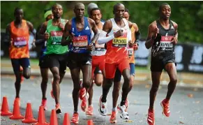  ??  ?? Long distance runners, such the ones seen here during the 2020 London Marathon in October, tend to have smaller calf muscles. — AFP