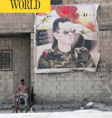  ?? YOUSSEF KARWASHAN / AFP / GETTY IMAGES ?? A Syrian soldier sits by the entrance of the Wafideen Camp ahead of the arrival of rebels and their families evacuated from the Eastern Ghouta town of Douma Thursday, ending one of the bloodiest assaults of Syria’s seven-year war.