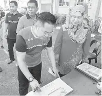  ??  ?? NILAI MURNI: Mohd Rashdey menuliskan nama di buku tamu ketika hadir merasmikan Gotong-Royong Perdana Bersama Ibu Bapa di SK Tagasan, Semporna baru-baru ini.