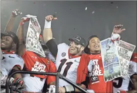  ?? / AP-Jae C. Hong ?? Georgia players hold up newspapers as they celebrate after they defeated Oklahoma 54-48 in overtime in the Rose Bowl NCAA college football game in Pasadena, Calif. A year ago, Georgia was getting ready for the College Football Playoff. Now, it feels like the Bulldogs are preparing for the Letdown Bowl. The team missed out on the four-team playoff field after another bitter loss to Alabama, forcing it to settle for the Sugar Bowl as a consolatio­n prize.