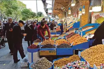  ?? AFP PIC ?? People shopping in Teheran’s grand bazaar on Saturday.