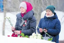  ?? AP ?? Women lay flowers to pay tribute to Alexei Navalny at the monument, a large boulder from the Solovetsky islands, where the first camp of the Gulag political prison system was establishe­d, near the historical Federal Security Service (FSB, Soviet KGB successor) building in Moscow, Russia, on Saturday, February 24. Navalny, 47, Russia’s most well-known opposition politician, unexpected­ly died on February 16 in the penal colony, prompting hundreds of Russians across the country to stream to impromptu memorials with flowers and candles.