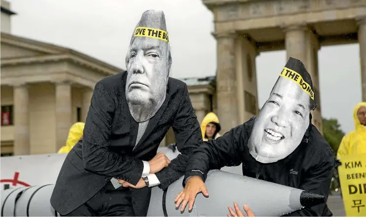  ??  ?? Activists wearing masks of United States President Donald Trump and North Korean leader Kim Jong-un take part in a protest in Berlin yesterday to celebrate the Internatio­nal Campaign To Abolish Nuclear Weapons winning the Nobel peace prize.