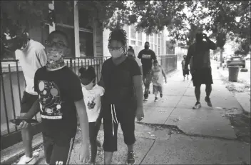  ?? ASSOCIATED PRESS ?? ST. FRANCIS XAVIER SCHOOL STUDENTS and their families walk together in Newark, on Thursday after discussing the Catholic school’s permanent closure announced the previous week by the Archdioces­e of Newark. Nationwide, more than 140 Catholic schools will not reopen in the fall.
Trump end run around Congress raises questions on his claims