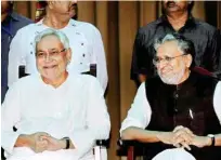  ??  ?? Nitish Kumar with senior BJP leader Sushil Kumar Modi at an oath ceremony function, at Raj Bhawan in Patna on Thursday