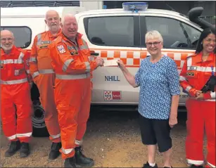  ?? ?? THANK YOU: Volunteers from Nhill VICSES unit receive a donation from Lowana Cottage Craft volunteer Sadie Williams.