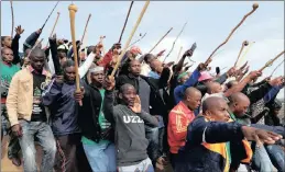  ?? PHOTO: AP ?? Mine workers protest near Marikana in this file photo. Violent community protests around the company’s Marikana operations forced it to temporaril­y close two smaller shafts last week amid concerns for workers’ safety.