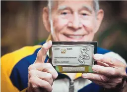  ?? MARLA BROSE/JOURNAL ?? Jamie Deuel displays a plaque he received for directing the World Schoolboy Wrestling Championsh­ips in Albuquerqu­e in 1978. He thinks the plaque should be exhibited in a public place to commemorat­e the event, which drew 200 competitor­s from about a...