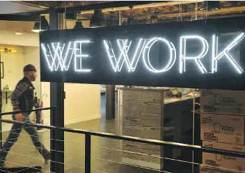  ?? MANDEL NGAN/AFP/GETTY IMAGES FILES ?? A man enters the WeWork coworking space in Washington, D.C. Seattle-based Amazon Inc. swiftly scooped up most of New York-based WeWork Inc. shared office spaces in Vancouver. It will be renting WeWork’s first Vancouver office site, as it does not want...