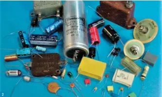  ??  ?? Fig. 1: The basic constructi­on of a capacitor. Fig. 2: A selection of capacitors used in electronic circuits. Fig. 3: Symbols used for capacitors. Fig. 4: Simple circuit showing how charge builds on the capacitor. Fig. 5: As Fig. 3 but with a switch to allow the direction of current flow to be reversed. Fig. 6: Using analogue meters to observe current flow in a capacitor. Fig. 7: The effect of applying a sinewave voltage across a capacitor. 2