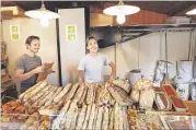  ?? RODOLPHE ESCHER / THE NEW YORK TIMES ?? Maud Moinard (right) bakes and sells high-quality bread in La P’tite Boulangeri­e, Pascal Rigo’s tiny bakery in Cap Ferret, France.