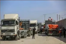  ?? Samar Abu Elouf/The New York Times ?? Humanitari­an aid arrives through the Rafah crossing into the Gaza Strip on Oct. 21. The number of trucks entering Gaza with food and other aid rose in early March compared to February, according to United Nations data.