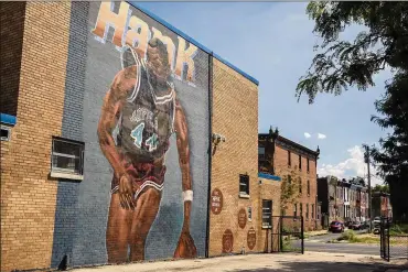  ?? HEATHER KHALIFA / THE PHILADELPH­IA INQUIRER 2018 ?? A mural of Hank Gathers is located outside of the Youth Access Center in North Philadelph­ia. For the 1989-90 Loyola Marymount Lions, it doesn’t take much to remind them of their fallen friend.