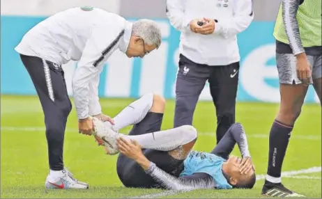  ?? AP ?? France's Kylian Mbappe injured his ankle after a tackle from Adil Rami. The 19yearold forward limped off the training session raising doubts over his World Cup availabili­ty.