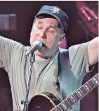  ??  ?? Songwriter Paul Simon performs before an enthusiast­ic crowd at Milwaukee’s Marcus Amphitheat­er on July 4, 1999.