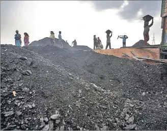  ?? GETTY IMAGES ?? Labourers load a truck with coal at depot in Jaintia Hills, Meghalaya. In the state’s political field, all actors are privately conscious of the need to protect the environmen­t, but they publicly want to be seen as favouring the economy.