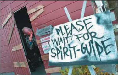  ?? TANIA BARRICKLO — DAILY FREEMAN FILE ?? Jim Boice, owner of The Barn of Terror on Old Kings Highway in Saugerties, snacks while dressed as a flesh-eating zombie.