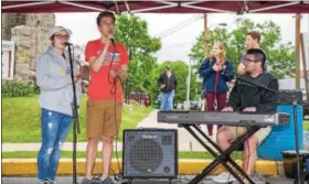  ?? SUBMITTED PHOTO - DENNIS KRUMANOCKE­R ?? Adam Rabenold accompanie­s Alayna Biltcliff and Kjalar Kollmor during a performanc­e at the Topton Street Fair.