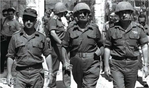  ?? (Reuters) ?? THEN DEFENSE minister Moshe Dayan, army chief of staff Yitzhak Rabin and Jerusalem commander Uzi Narkis walk through the Lion’s Gate into Jerusalem’s Old City in June, 1967 during the Six Day War.